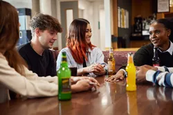 A group of students sat talking over drinks at Treforest Student's Union