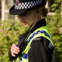policing student in uniform talking into radio