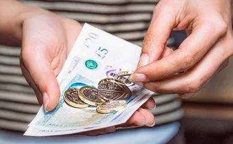 A close up of someone holding money in their hands.