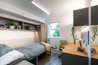A bedroom decorated with plants and photos at our Pontypridd accommodation.