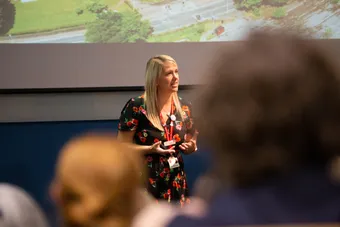 A lecturer giving a subject talk in a lecture theatre at an open day.