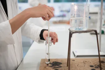 student in chemistry lab using equipment