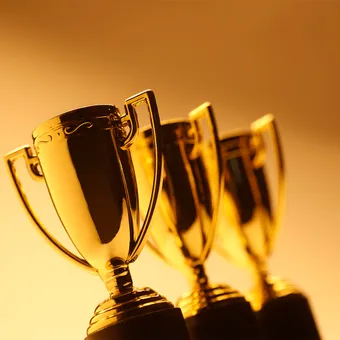 A set of 3 gold trophies