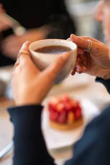 Close up of a woman drinking coffee
