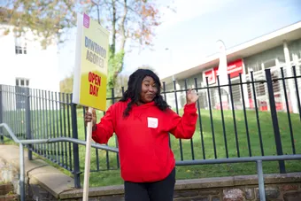 Student holding a welcome sign at a USW Open Day in Treforest