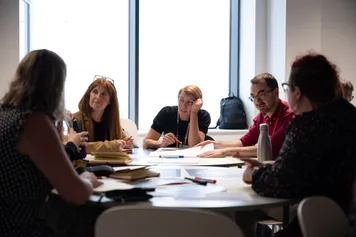 A group of attendees sound around a table at a CELT conference