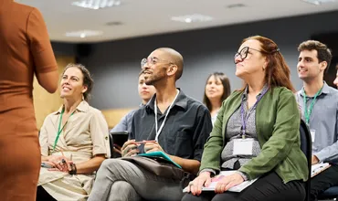 A group of people from different organisations and workplaces attending a short course session