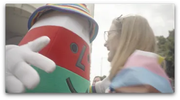 A person smiling as they go towards Mr Urdd.