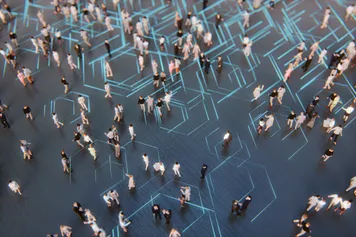 high level image of people walking over a dark blue floor