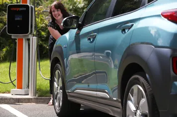 A student charges their electric car