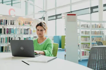 Student using a laptop to study at Newport campus