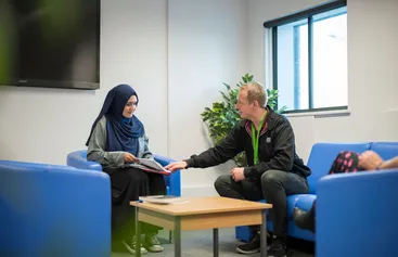 Two people sat in the therapy clinic at Newport campus