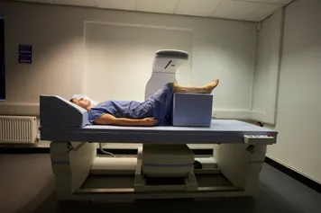 A Chiropractic clinic patient being scanned by the DXA scanner