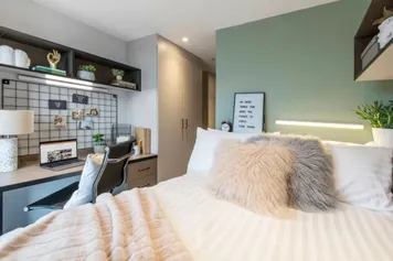 A comfortable bedroom with a double bed, desk and stylish decor