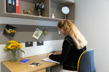 a student sitting at a desk in a premium room in glamorgan court in pontypridd