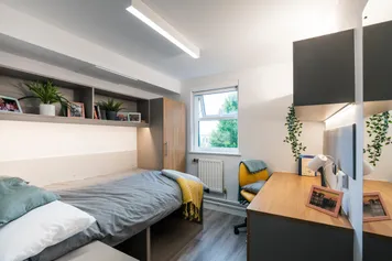A bedroom decorated with plants and photos at our Pontypridd accommodation.