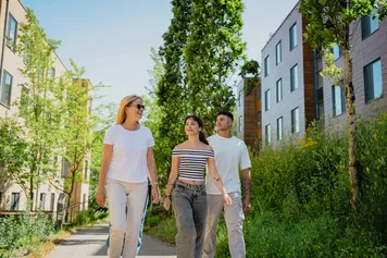 Three students walking outside past the Treforest campus accommodation.