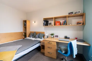 A bed and desk at a double room in a Pontypridd accommodation block.