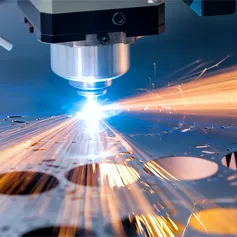 An extreme close up of a piece of machinery cutting metal with a laser