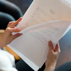 A hand holding a script