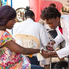 Public health nurse treating a patient at a community clinic