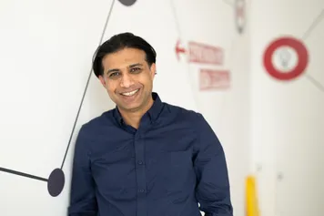 A professional photograph of Md Palash Kamruzzaman smiling at the camera.