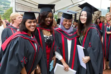 A group of students celebrating at graduation.