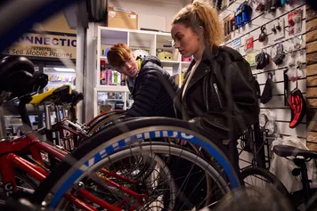Two students look at the different bicycles on sale at a shop in Pontypridd Market.
