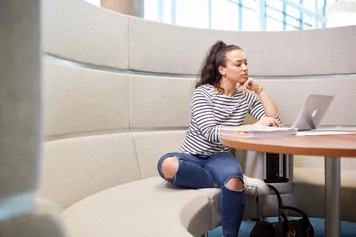 Student using a laptop to study at Newport campus