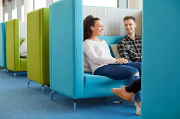 two students sat in the library talking