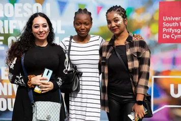 Three students smiling at the camera at Treforest Welcome Fest