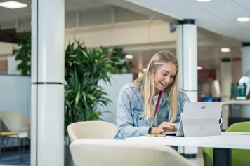 student sat on a laptop working in Stilts, Treforest