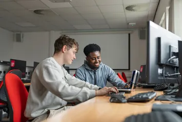 Two students working in the computer lab.