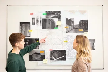 students working together looking at evidence on a wall