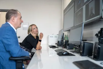 two people looking up at hydra simulation centre screens