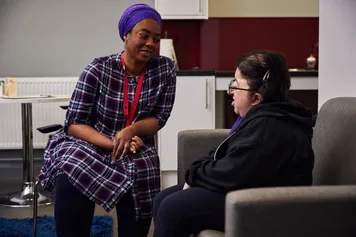A nursing student is having a conversation with a real-life patient.