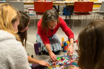 Art Psychotherapy students in a classroom using art materials