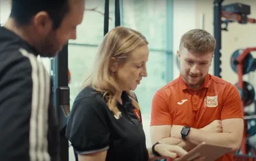 sport therapy researchers talking to student