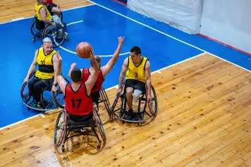 Two teams play wheelchair basketball