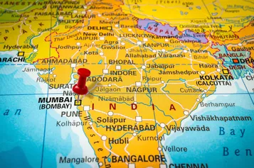 Map of the world with a red pin placed on Mumbai