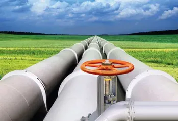 A picture of gas pipes with a field in the background.