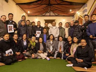 A diverse group of people stands together, smiling for a photo in a cozy room. 4. Several individuals pose happily for a picture in a bright, inviting room.