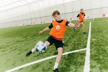 Sport students playing football