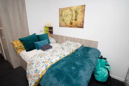 bed and framed picture on wall