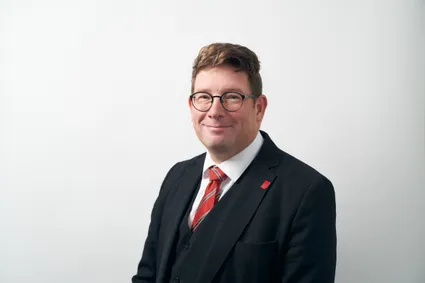 A profressional photograph of Martin Steggall smiling at the camera.
