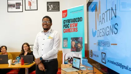 USW Careers staff standing in front of a USW Careers presentation screen