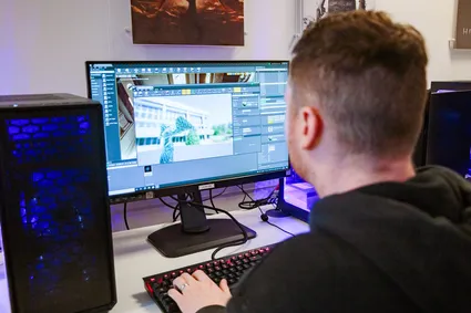 close up of computing student facing computer screen, to show him working on a project