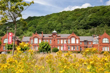 A landscape view of Glyntaff Campus behind flowers