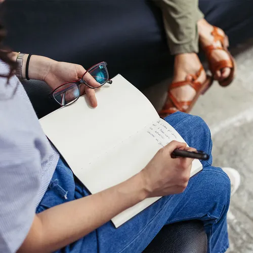 A close up of a counsellors notebook while making notes from a session with a patient