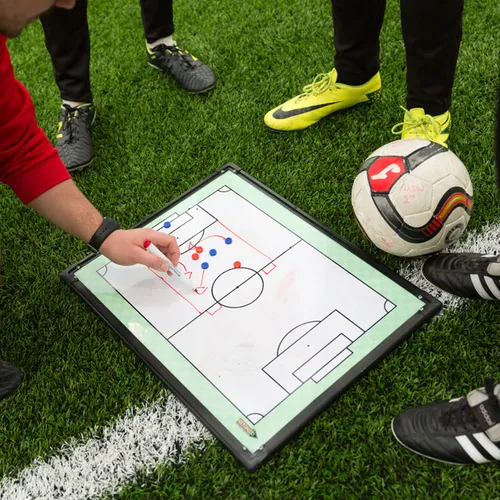 A close up of a whiteboard showing football strategy.